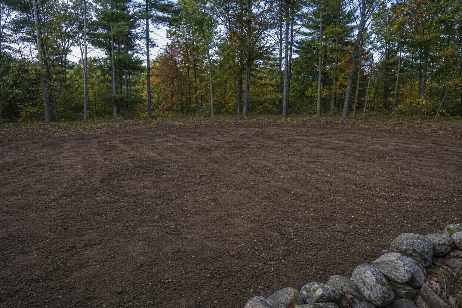 After: same hillside cleared, graded, and ready for construction